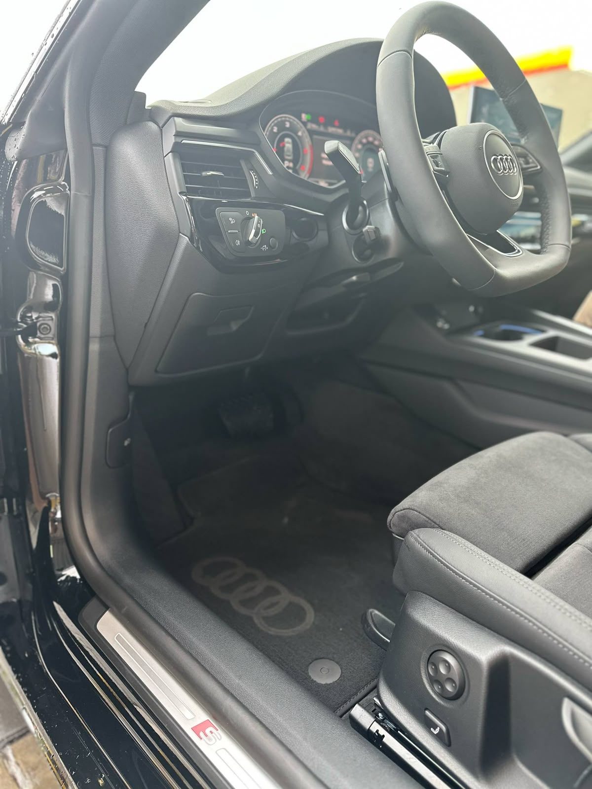 Fotel kierowcy i kokpit Audi A5 Sportback widziane przez otwarte drzwi
